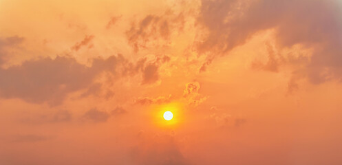panoramic natural sky background of sun rising over gloden cloudy sky