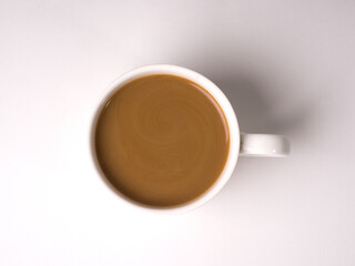 Coffee with milk in a white cup on a white background. Studio photography