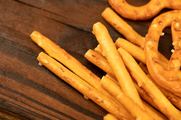 Salted breadsticks and salted pretzels scattered on the table.