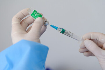 Doctor holds syringe with covishield vaccine Astrazeneca