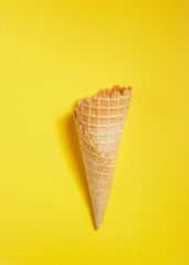 Sweet wafer cone on yellow background