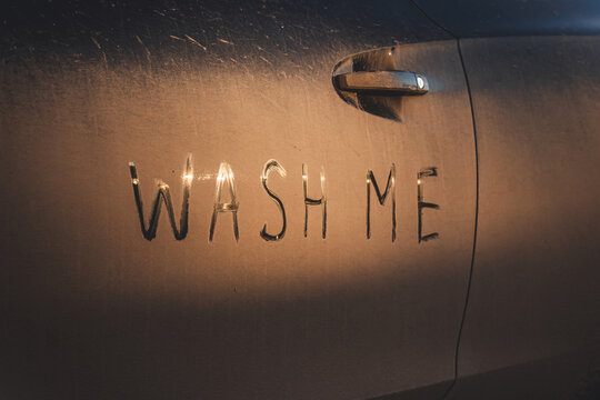Inscription wash me on dirty car