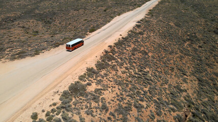 Aerial - School bus on desert road near Exmouth, Western Australia