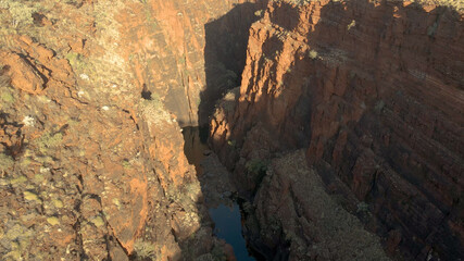 Aerial shot Over big Canyon In Karijini National Park with large Gorge and stream In Western Australia