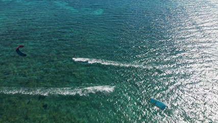 Aerial shot of kitesurfer surfing on board In Pacific Ocean during sunny day,Australia.