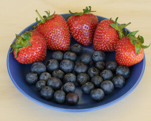 Strawberries and blueberries on a blue plate