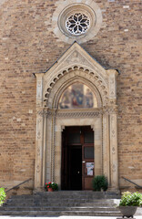 Fototapeta na wymiar The entrance to the ancient basilica. Tuscany, Italy