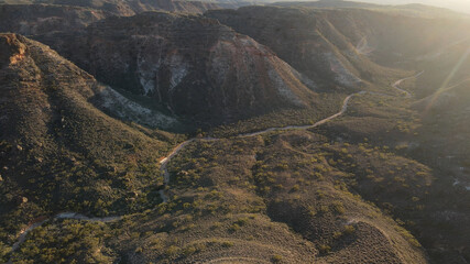 High drone view over a spectacular hilly red charles Knife Canyon on a foggy day during sunrise In...