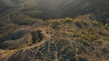 High drone view over a spectacular hilly red charles Knife Canyon on a foggy day during sunrise In Exmouth, Western Australia