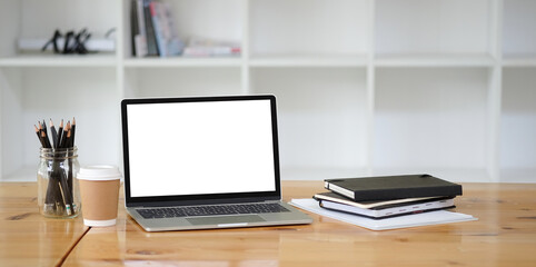Modern workspace with computer with blank screen and equipment on white table.Blank screen for your information.