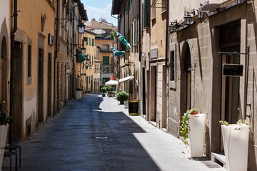 street in historical center of Arezzo with facade of medieval buildings. Tuscany, Italy