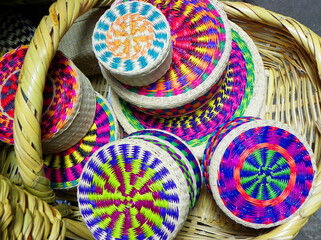 Wicker souvenirs baskets made from toquilla straw, vegetable fiber and painted with various colors at the artisan market in Cuenca, Ecuador