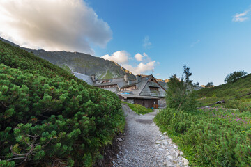 Fototapeta premium Beautiful views of the Polish High Tatras with mountain lakes and picturesque houses in the summer season