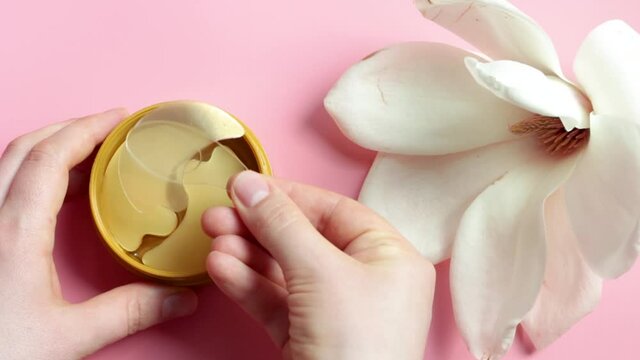 Transparent patches under in round jar on pink background top view.