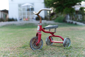 Old baby tricycle in the lawn