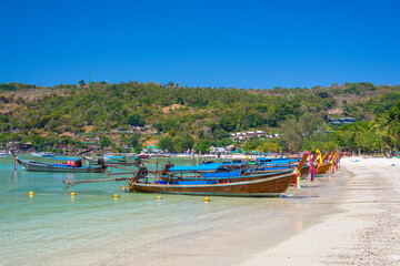 Fototapeta na wymiar Long tail boats on Phi phi island beach in Thailand
