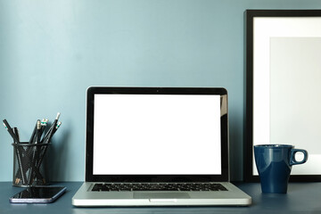Fototapeta premium Modern workspace with computer with blank screen and equipment on white table.Blank screen for your information.