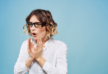 Beautiful woman with curly hair wearing glasses gestures with her hands Copy Space