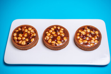 cake with caramel and nuts on a blue background