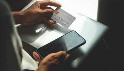 Close up view of man holding credit card. Online shopping or online payment.
