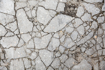 The remains of cracked asphalt on the ground. Top view