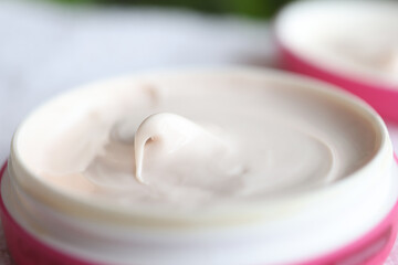 Closeup of pink jar of moisturizing cream