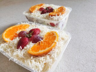 Fruit Salad With Cheese, Strawberry, Grape and Orange in Plastic Container.