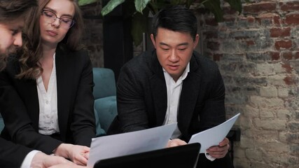 Startup investment confirmation meeting between asian investor and caucasian female startupper businesswoman colleagues shaking hands wearing casual formal business clothing in modern office workplace