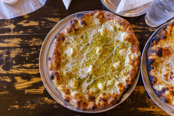 Tasty cheese and spices pizzas on vintage-looking table
