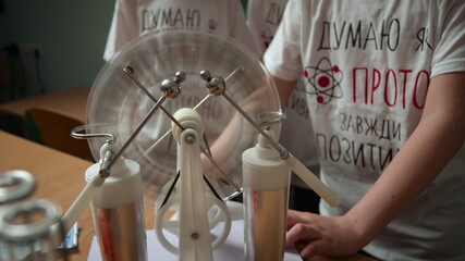 Close up unrecognizable students experimenting in physics class.Schoolchildren