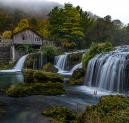 Fototapeta na wymiar waterfall in autumn at old mill
