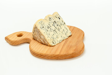 Fourme d'Ambert cheese on wooden cutting board