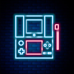 Glowing neon line Portable video game console icon isolated on brick wall background. Gamepad sign. Gaming concept. Colorful outline concept. Vector