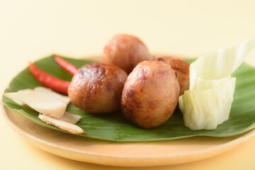 Thai sausage or Isan sausage, grilled fermented rice with minced pork and fresh vegetables