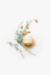 Composition with jar of natural cream on white background