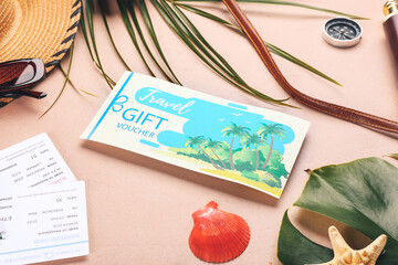 Set of travel accessories and gift voucher on color background