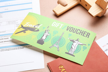 Set of travel documents, wooden airplane and gift voucher on color background