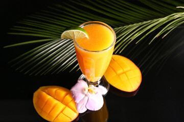 Glass of tasty mango margarita on dark background
