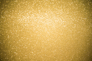 Gold glitters background. shimmering blur spot lights Bokeh Shiny gold light background.