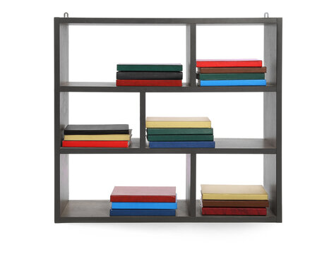 Modern shelf unit with books on white background