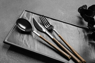 Stylish cutlery on dark background