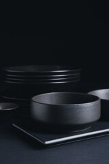 Stylish tableware on dark background