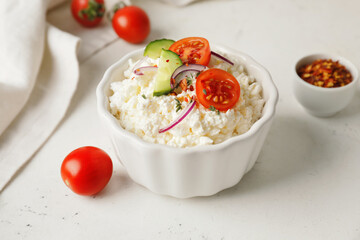 Bowl with cottage cheese on light background