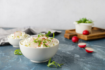 Bowls with cottage cheese on color background