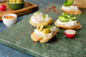 Tasty sandwiches with cottage cheese and vegetables on color background