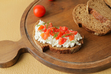 Tasty sandwich with cottage cheese and tomatoes on color background