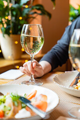 dinner in the restaurant, woman with white wine