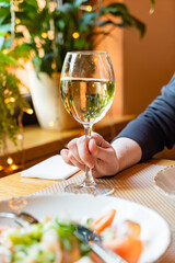 dinner in the restaurant, woman with white wine