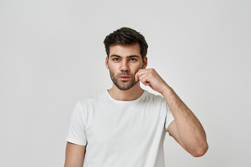 Fototapeta premium Man wearing t-shirt holding his cheek