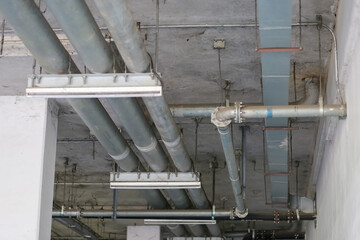 Plenty of metal pipes under the ceiling makes us wonder what these pipes are for.